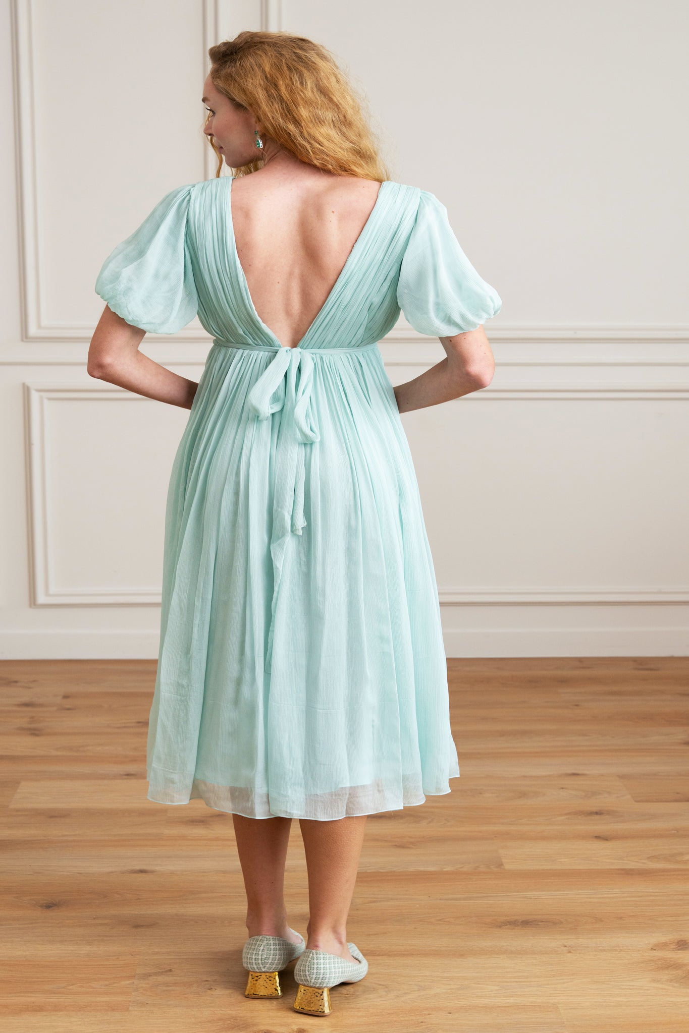 women wearing v-neck dress gathered or ruched effect short sleeve, midi length, silk dress