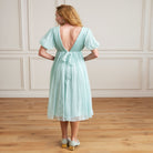 women wearing  v-neck dress gathered or ruched effect short sleeve, midi length, silk dress