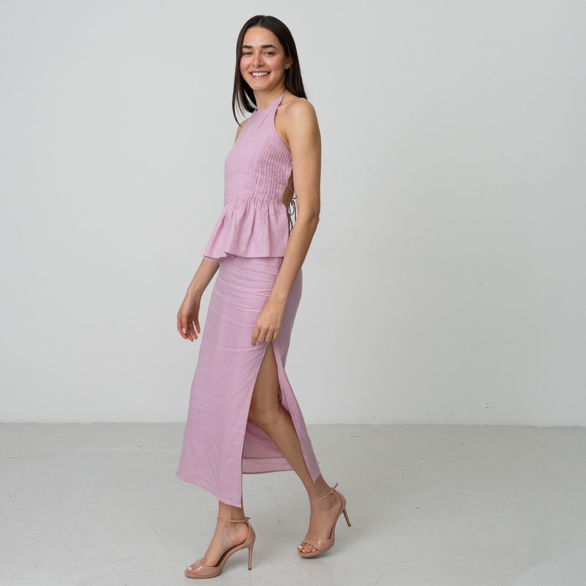 Woman wearing premium linen halter neck dress with high slits