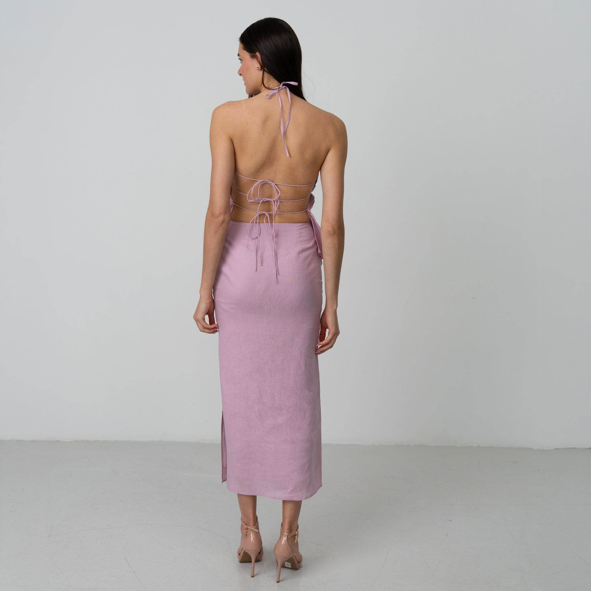 Woman wearing a pink backless dress in a premium linen