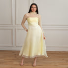 girl wearing yellow long dress with ruffles